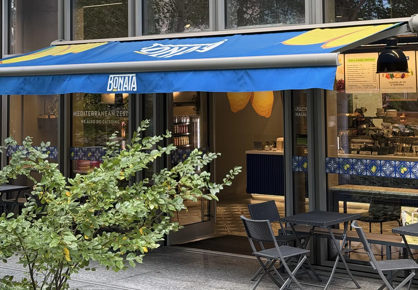 Bonata's shopfront: the blue awning, the open door and the tables outside